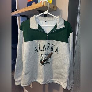 Shein, size medium quarter zip with Alaska design in the front.